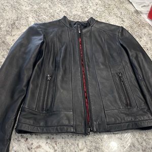 Black zip up leather jacket with red satin interior